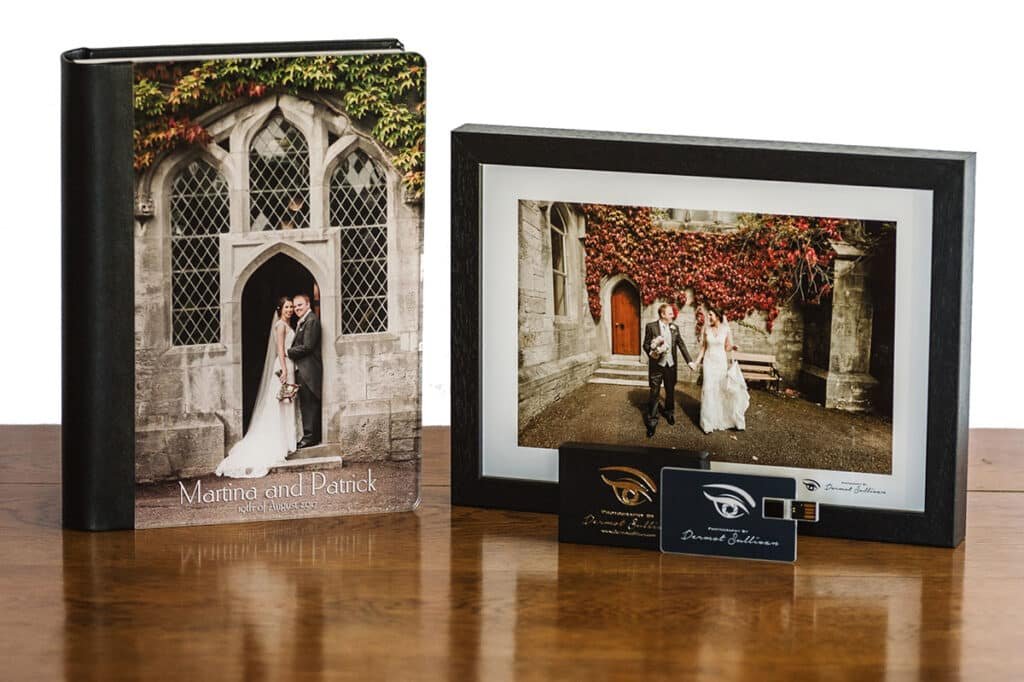 A Storybook Wedding Album and a framed Wedding Photograph on a shiny wooden table